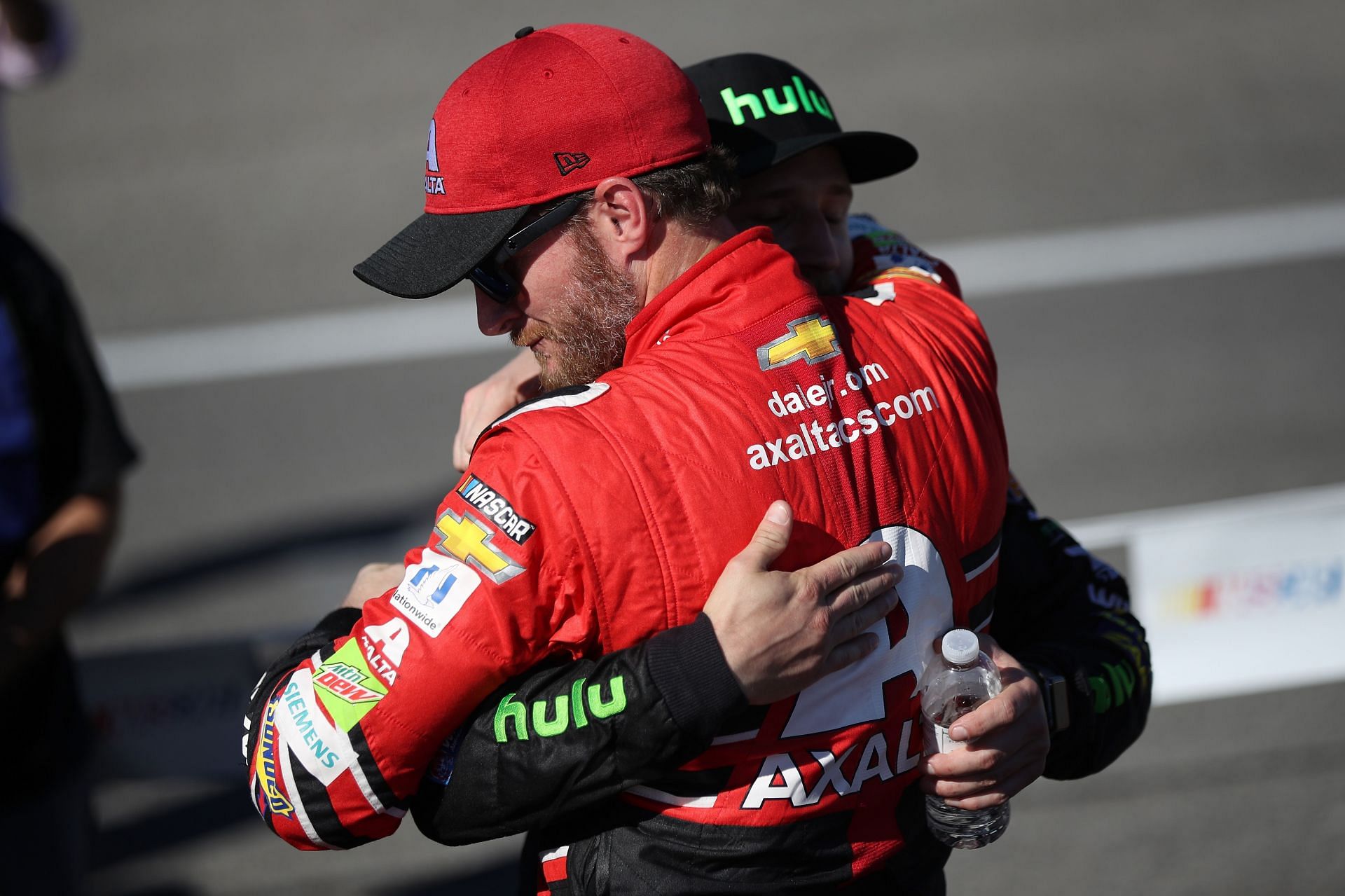 Dale Earnhardt Jr. (in red) hugs Jeffrey Earnhardt at Homestead-Miami Speedway on November 19, 2017. Source: Getty